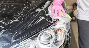 Person cleaning & waxing their car in Englewood, NJ