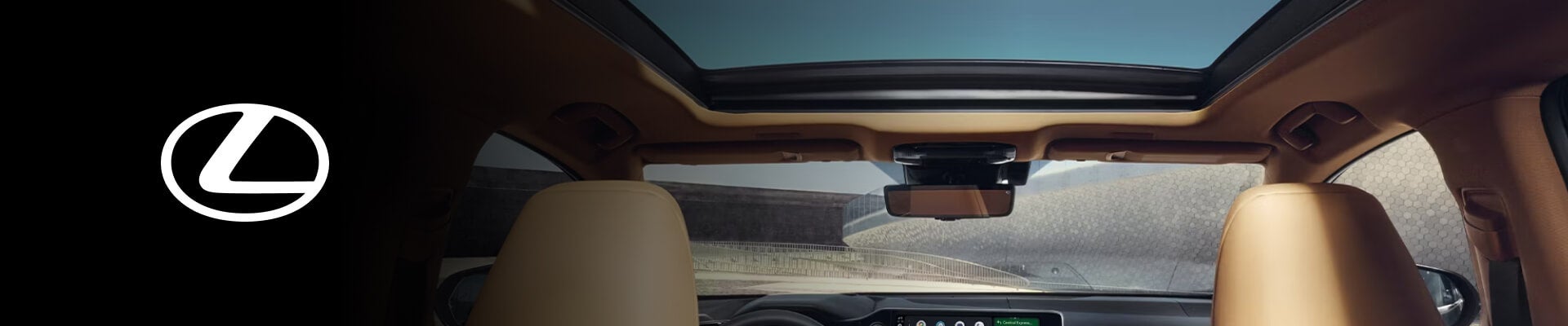 Interior perspective shot sowing a Lexus panoramic glass roof on a sunny day.